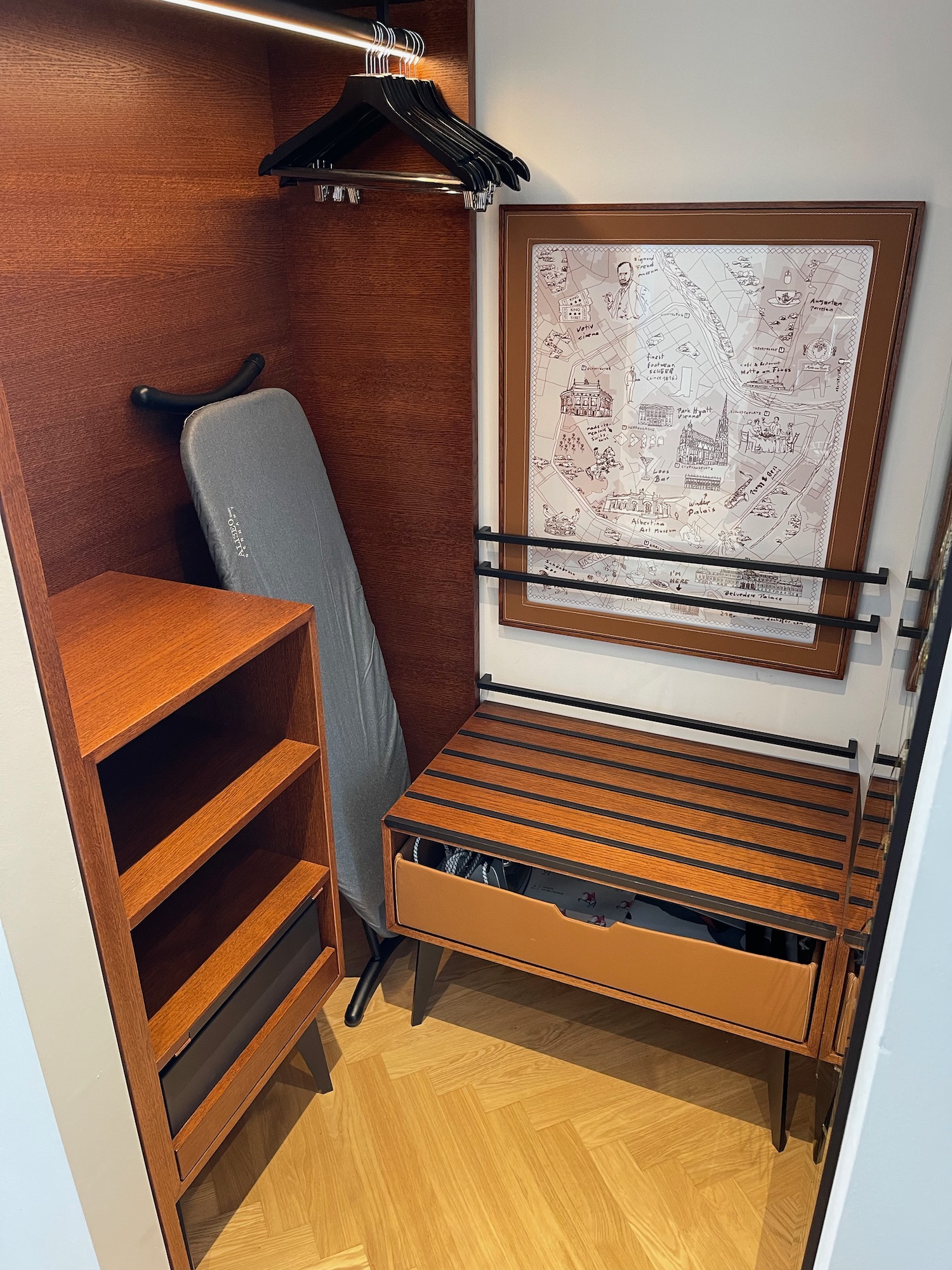 a closet with a bench and a mirror