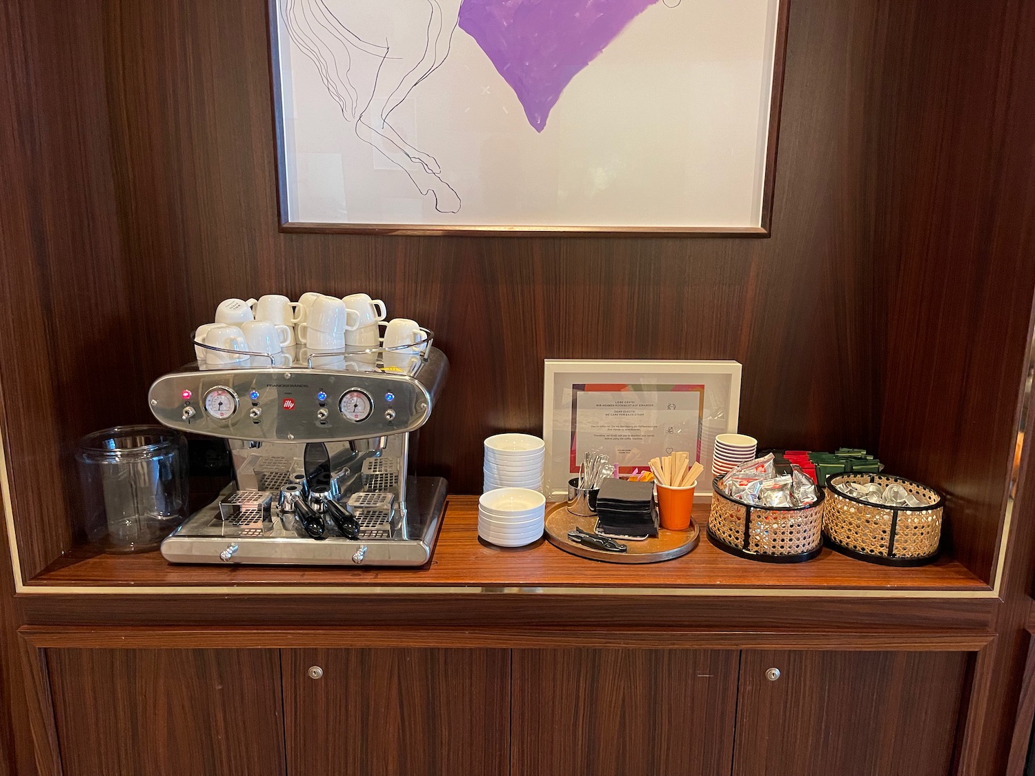 a coffee machine and cups on a counter