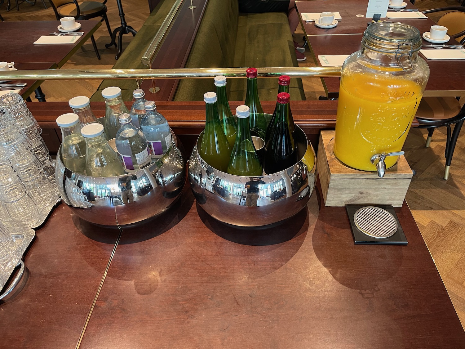 a group of bottles and a beverage dispenser on a table