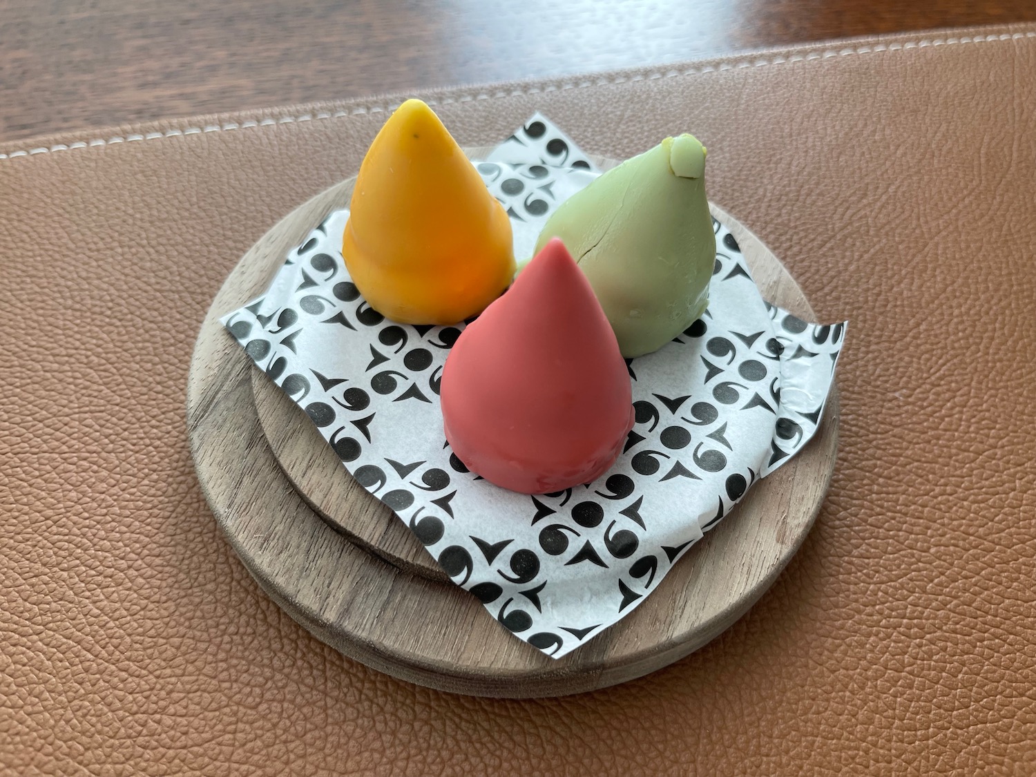 a group of colorful food on a wooden plate