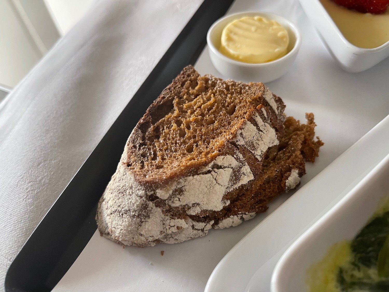 a slice of bread with butter on a tray