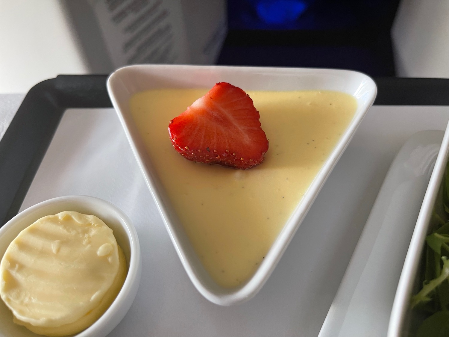 a white dessert with a strawberry on top