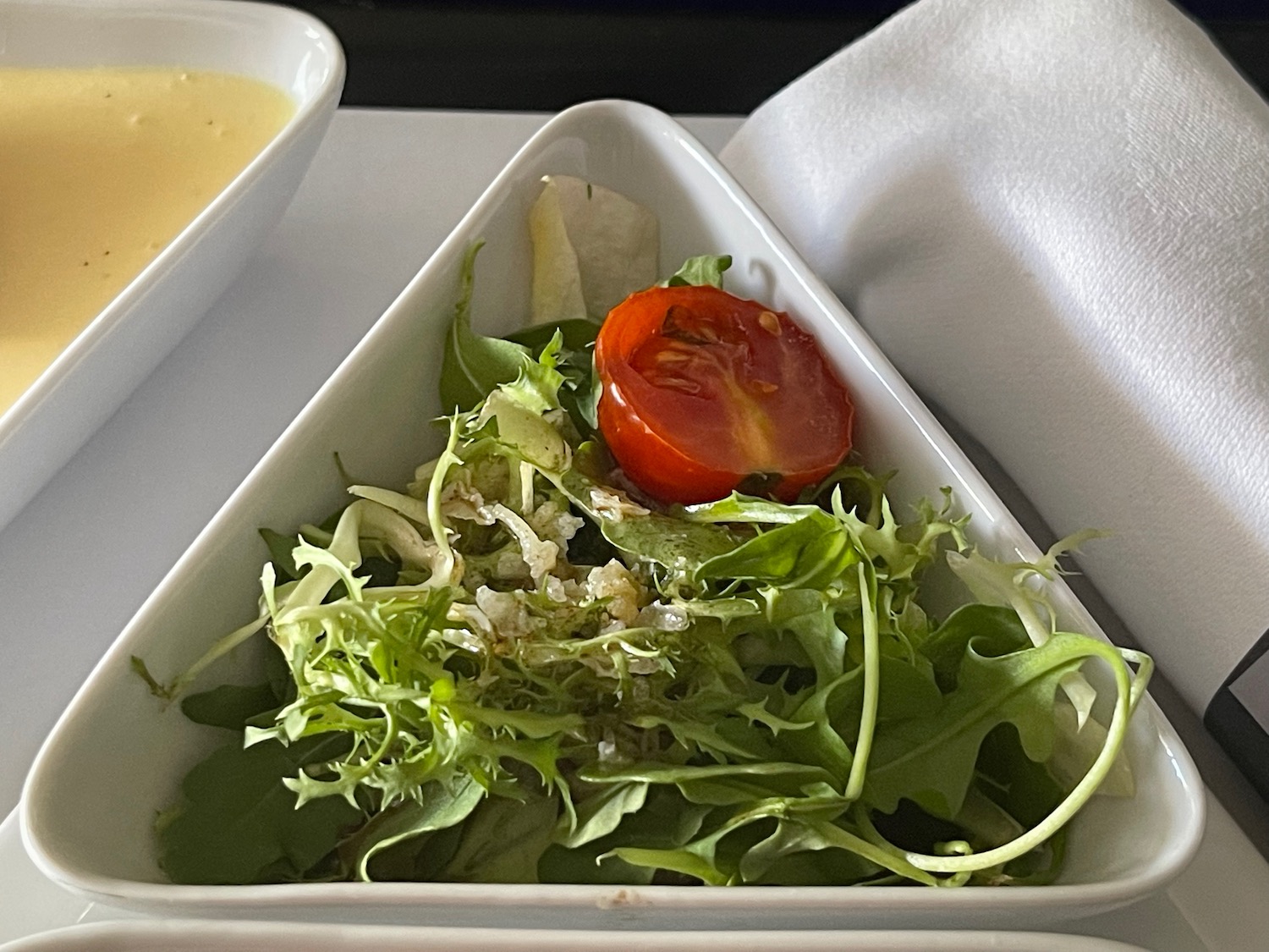 a salad in a rectangular white container