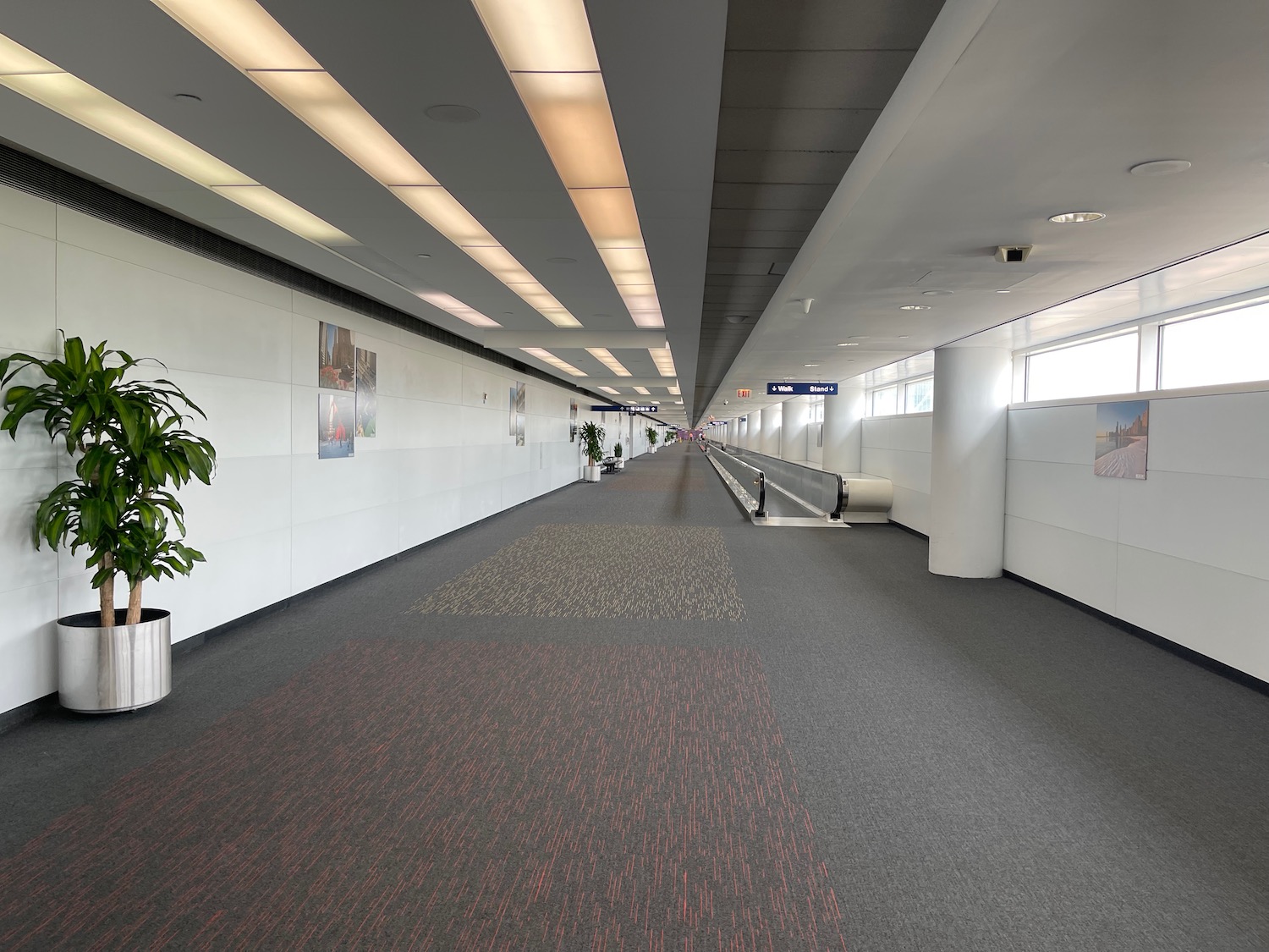 an empty hallway with escalator in a building