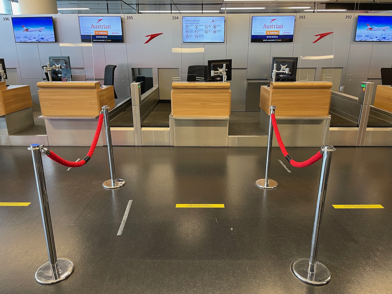 a red roped barriers in a airport