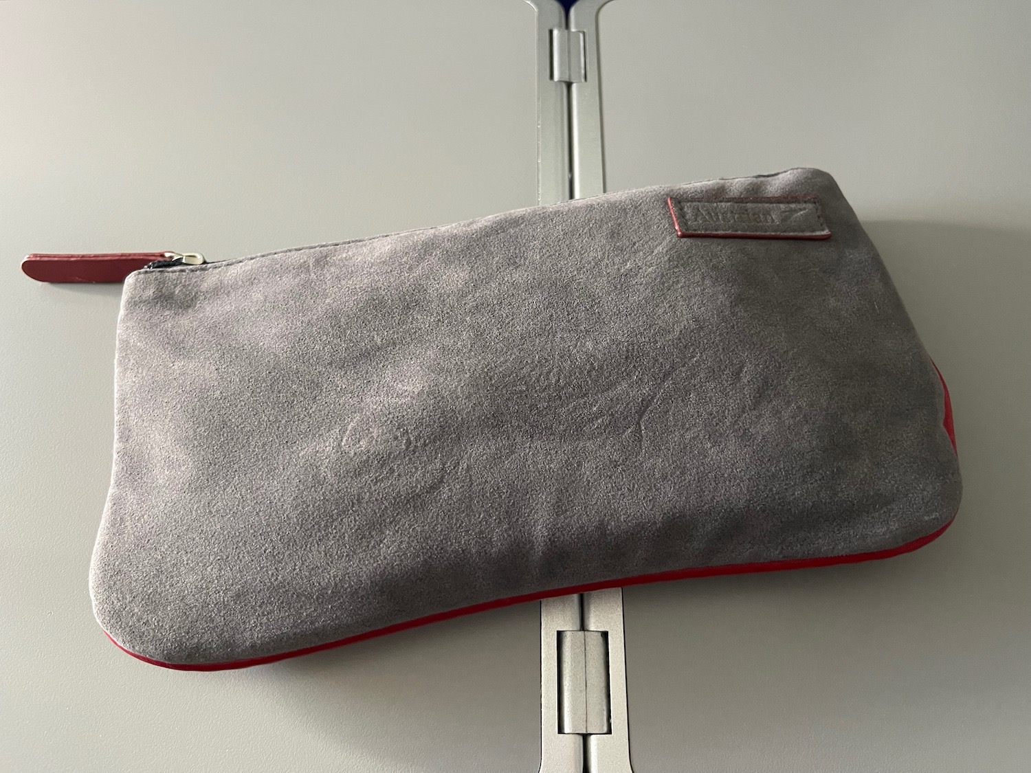 a grey bag on a silver surface