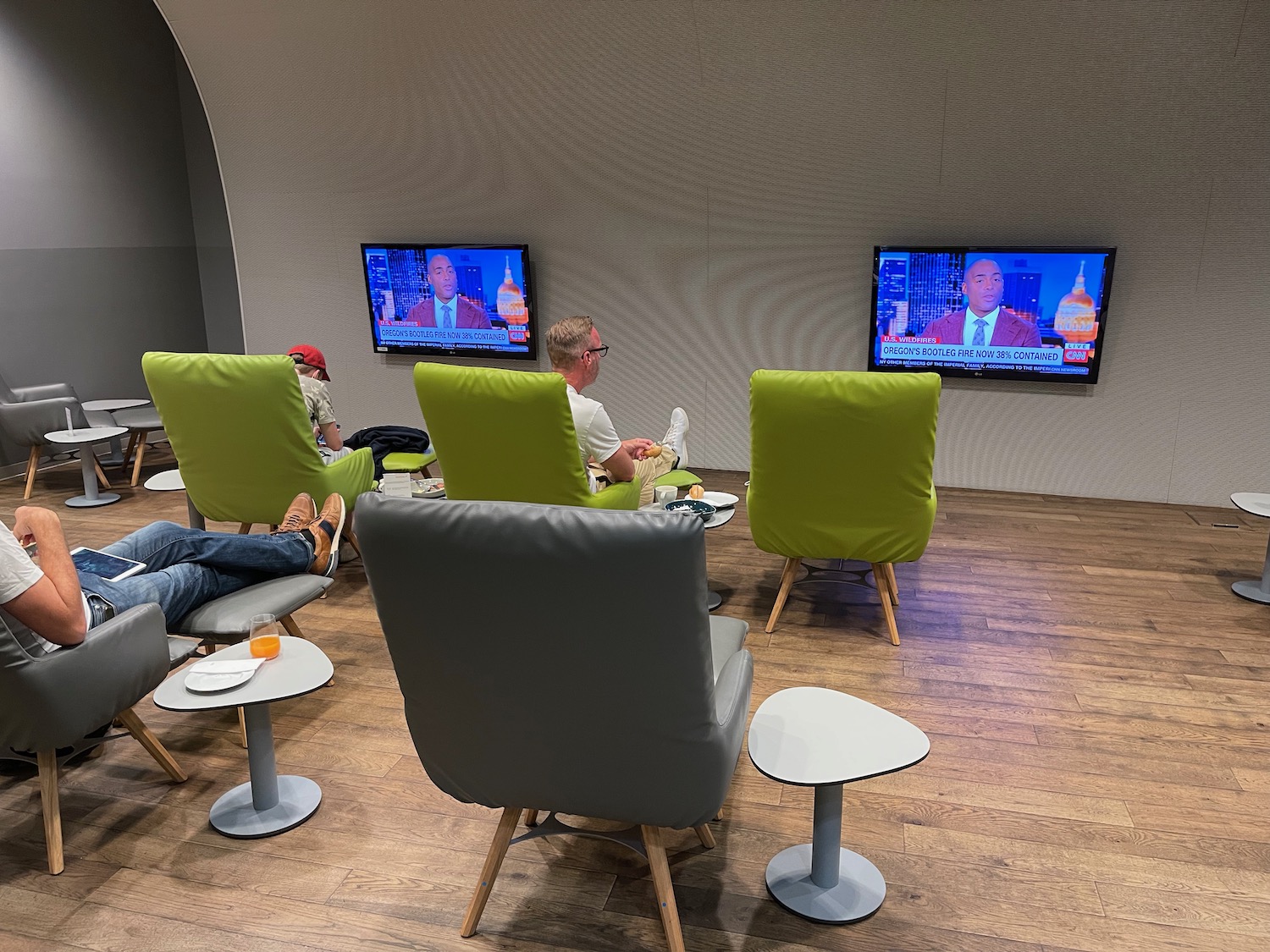 people sitting in chairs and a table with a television