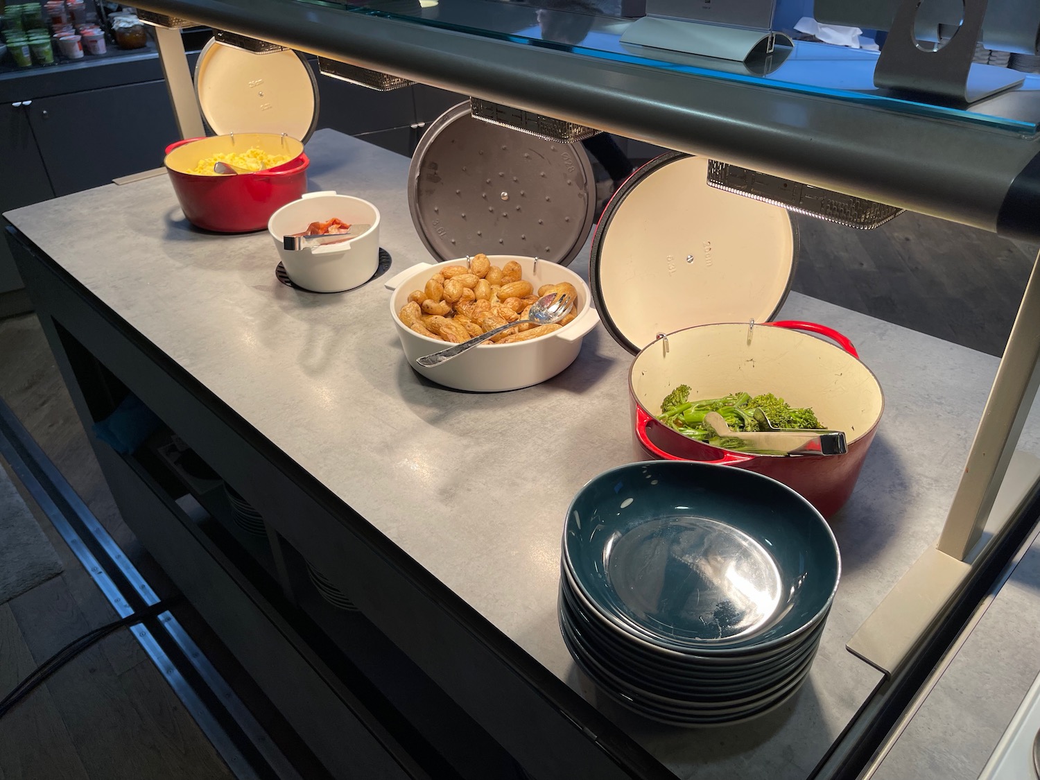 a buffet table with bowls of food