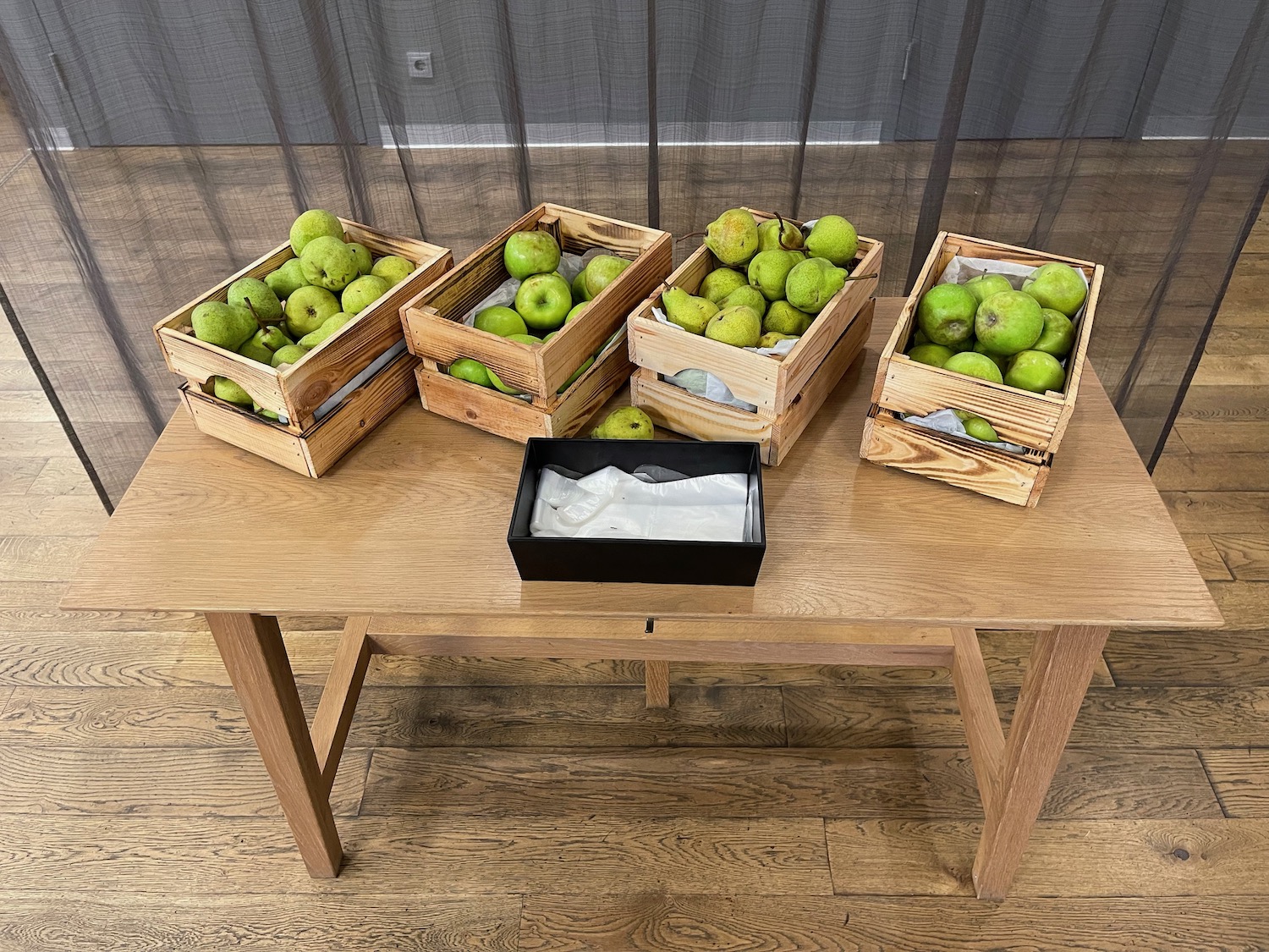 a group of wooden crates of apples on a table