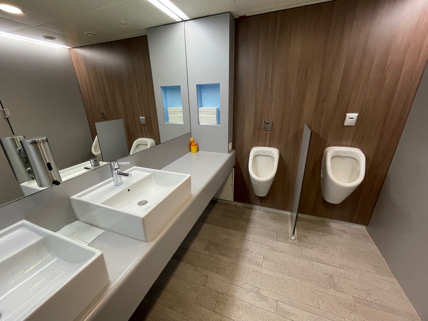 a bathroom with a sink and urinals