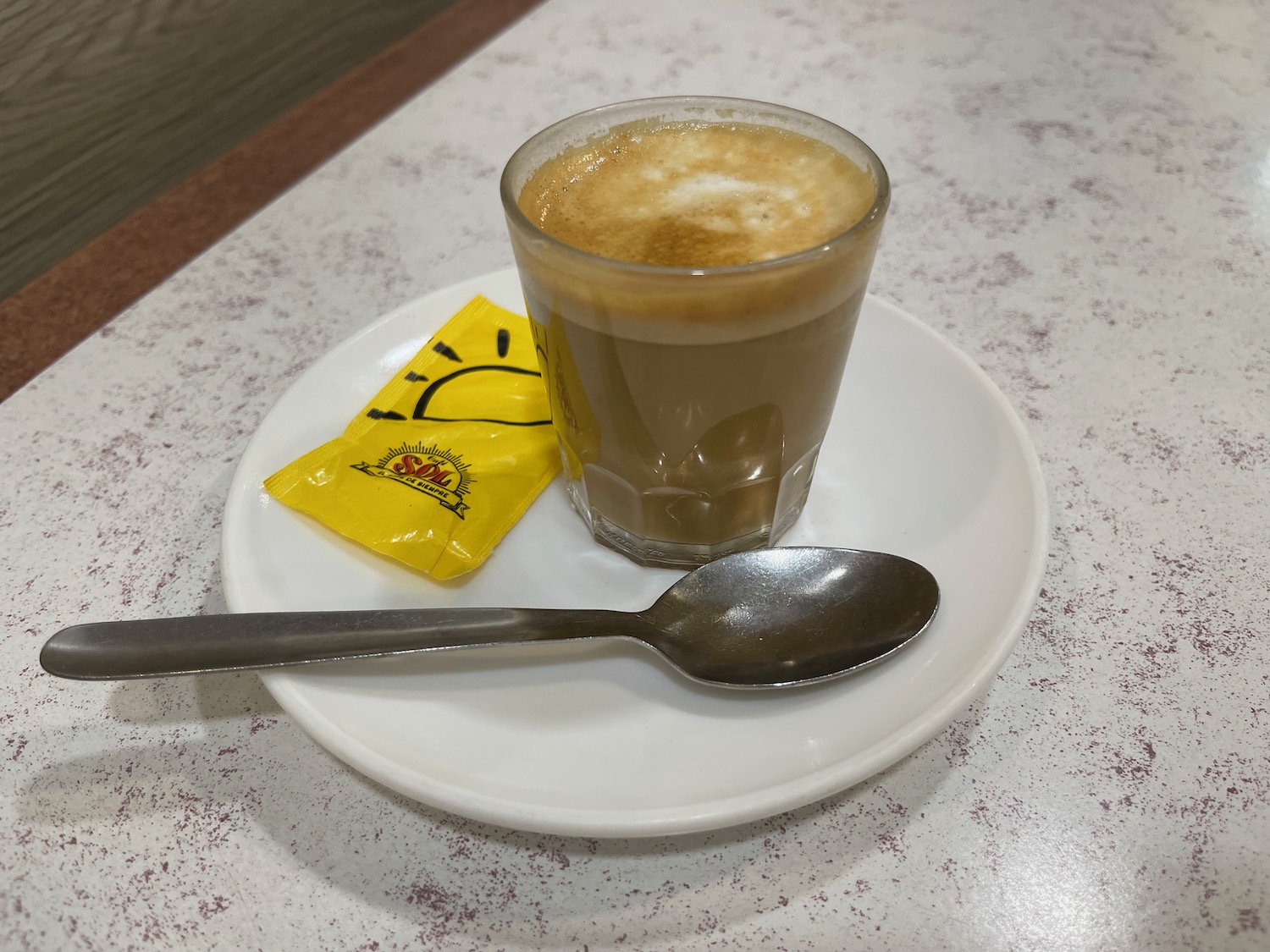 a cup of coffee and a spoon on a plate