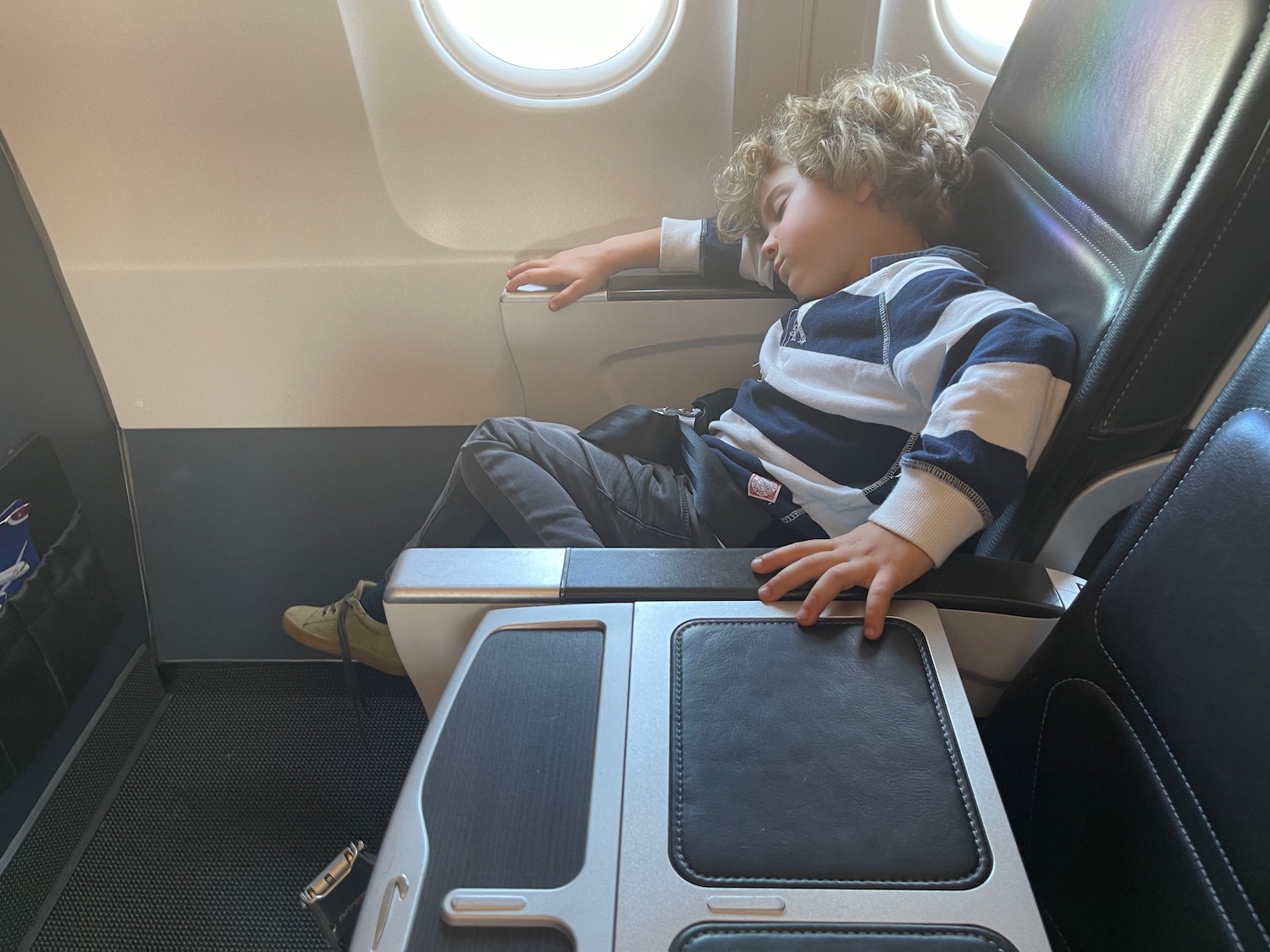 a child sleeping in an airplane