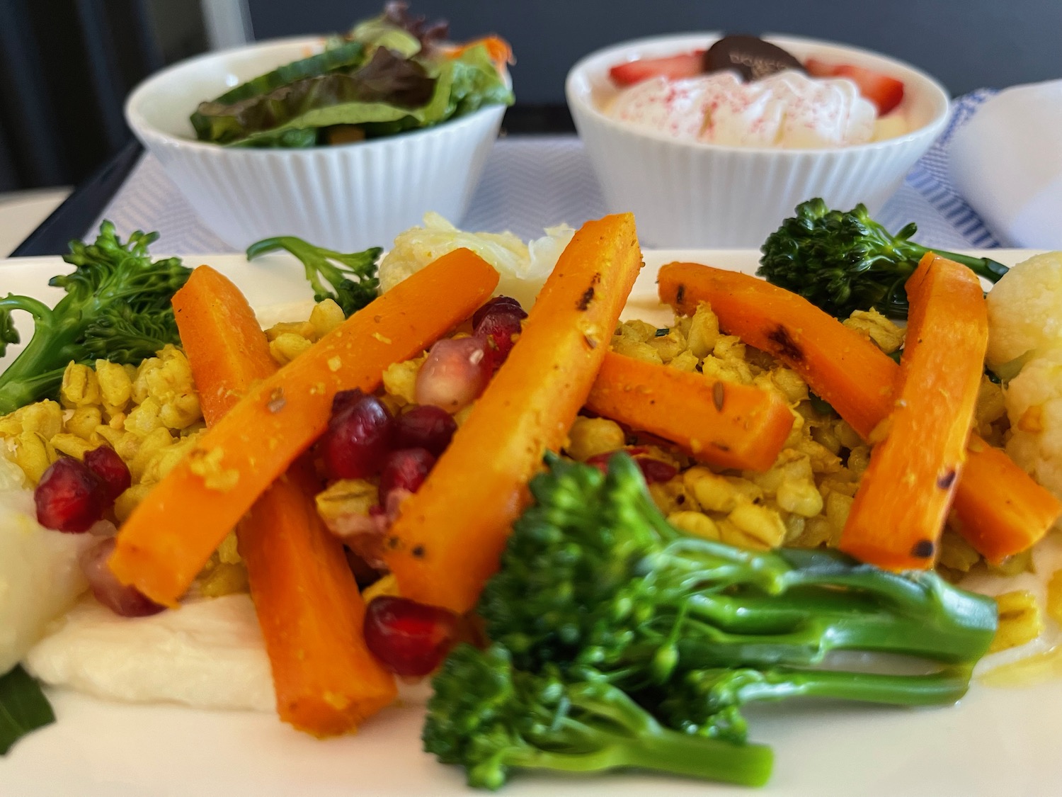 a plate of food with a couple bowls of salad