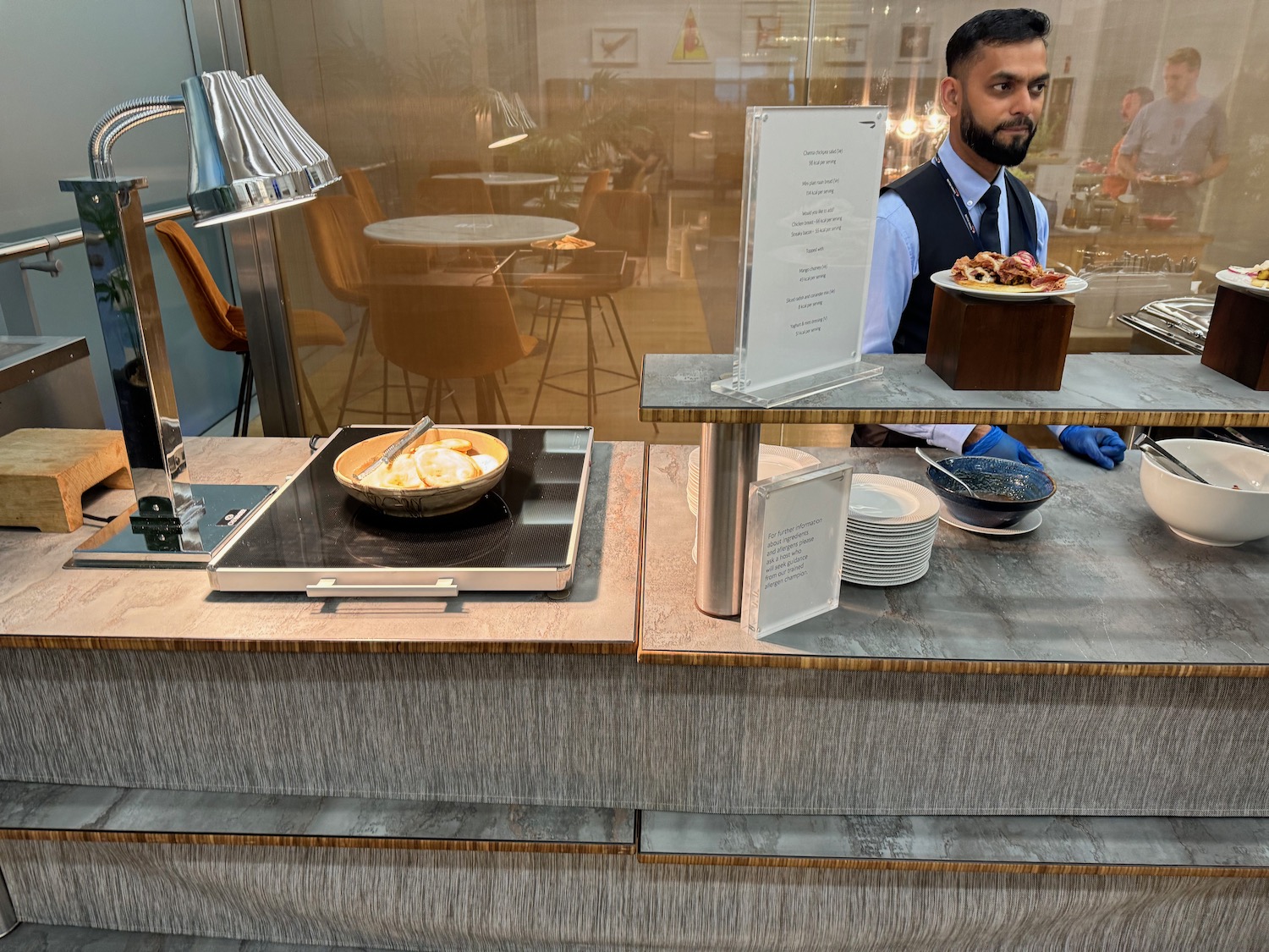 a man behind a counter with food on it