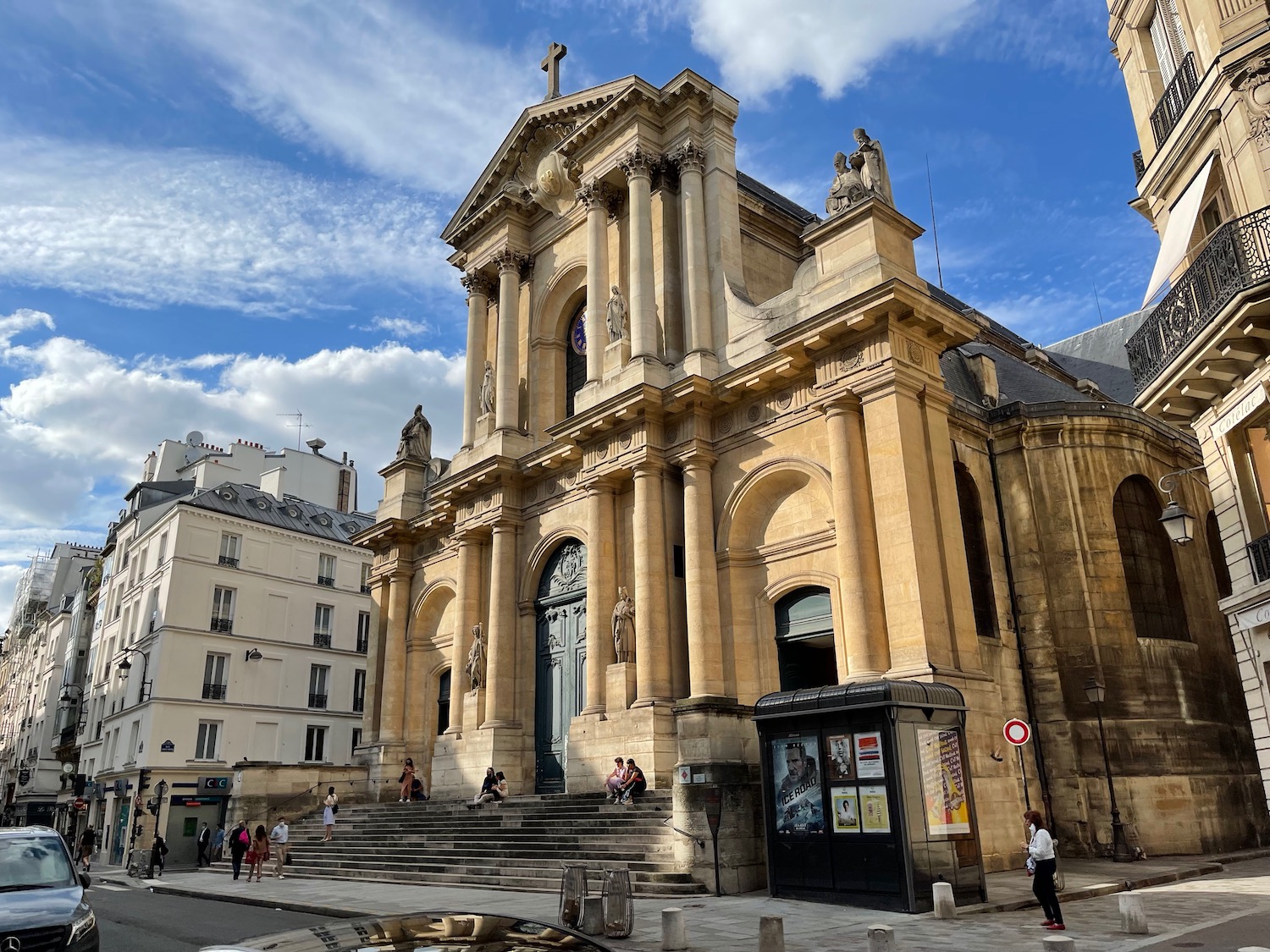 a large stone building with columns and a cross on top