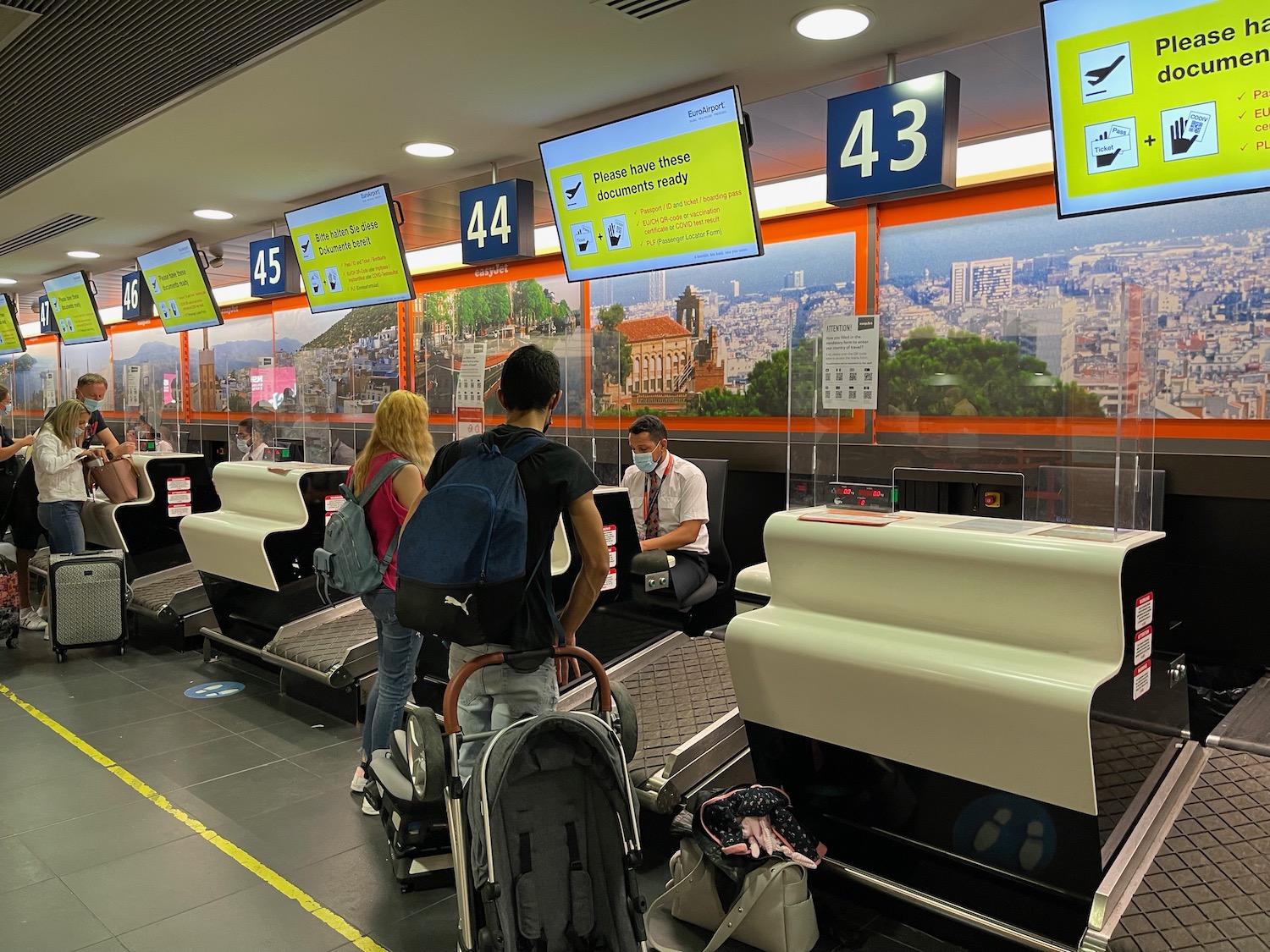 people standing in a room with luggage