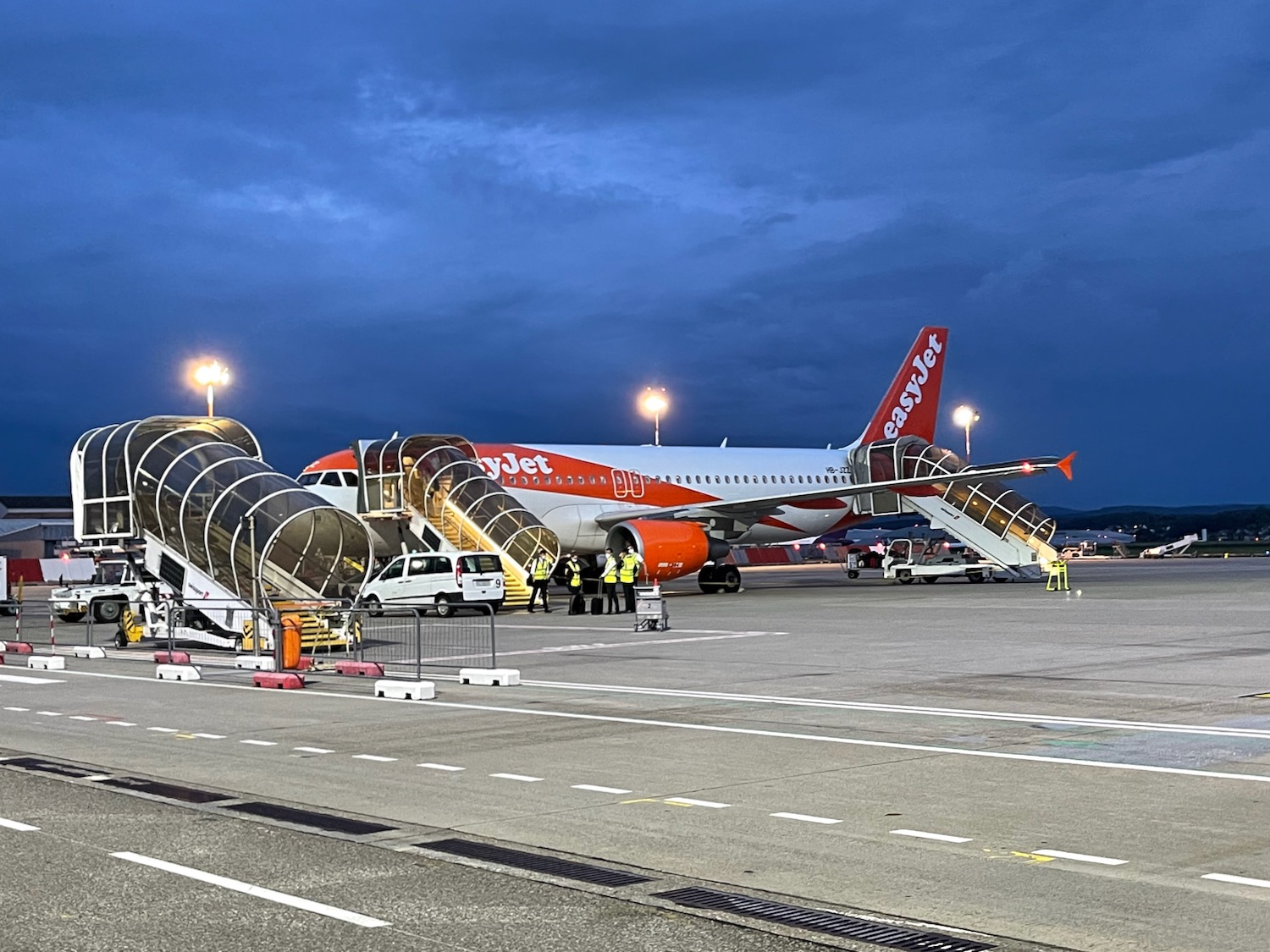 an airplane with stairs and people boarding