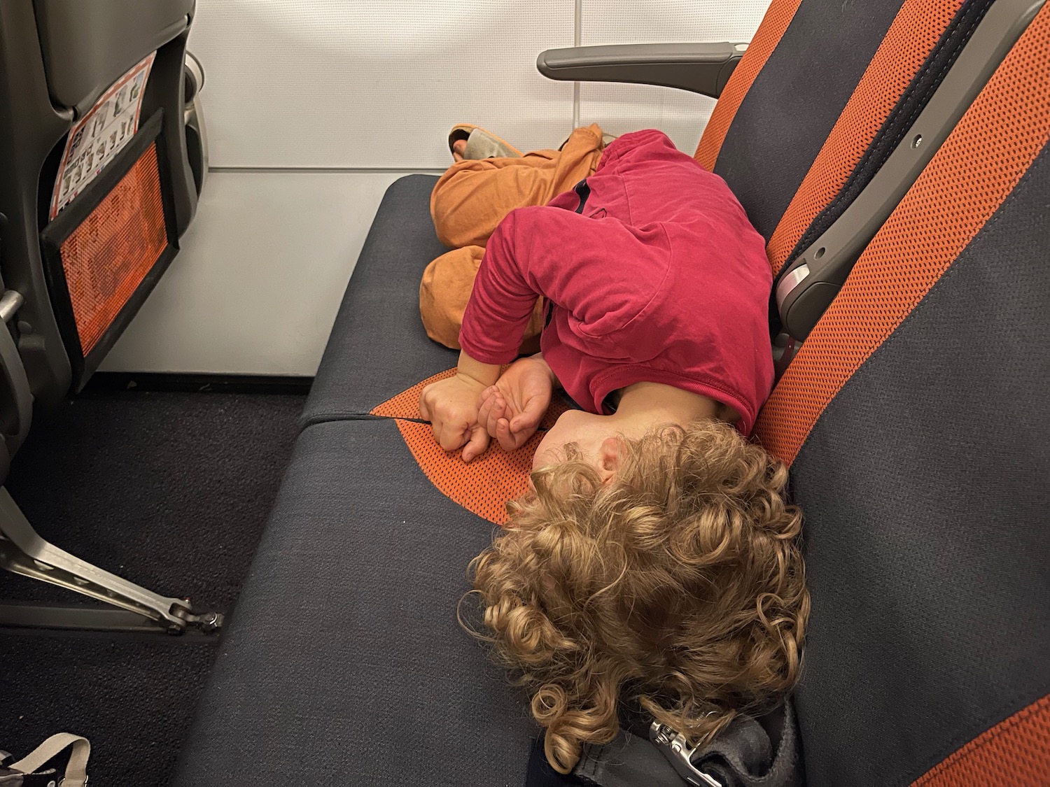 a child sleeping on a seat