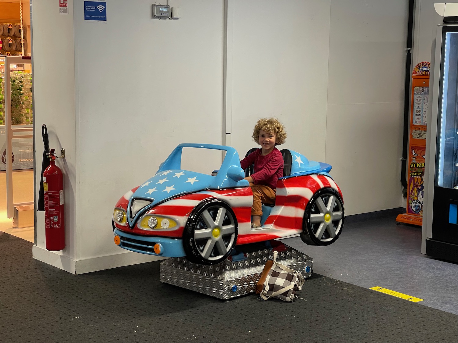 a child sitting in a toy car