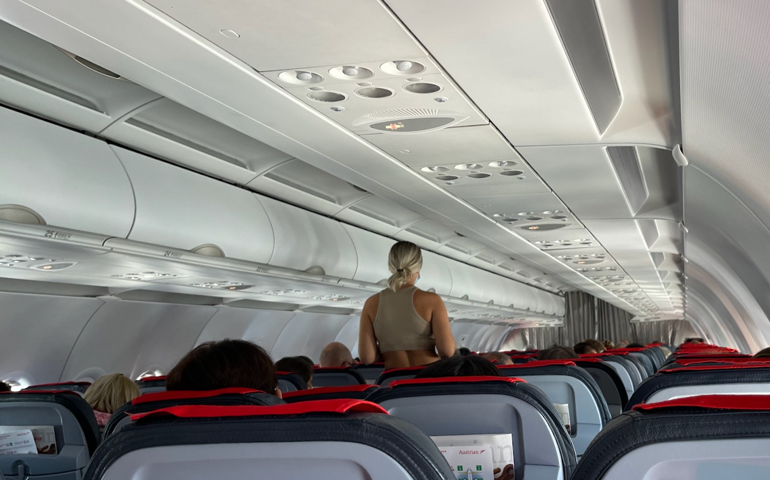 Flaunting Woman Struts Up and Down The Aisle On My Austrian Flight photo