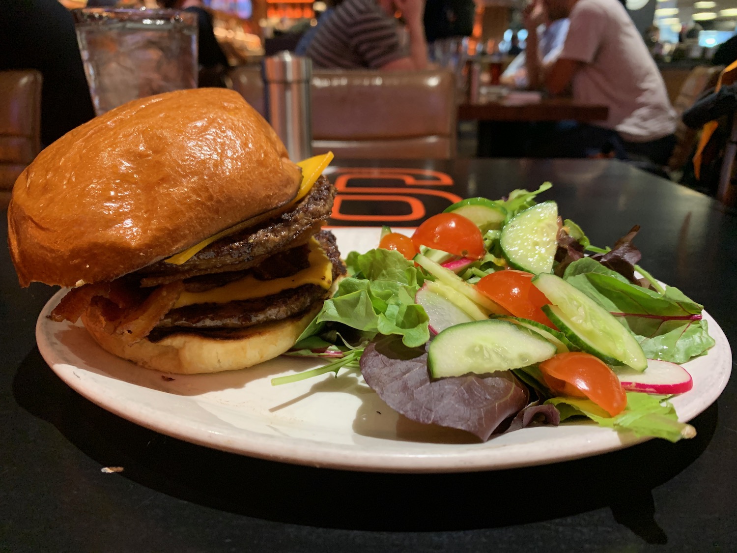 a burger and salad on a plate