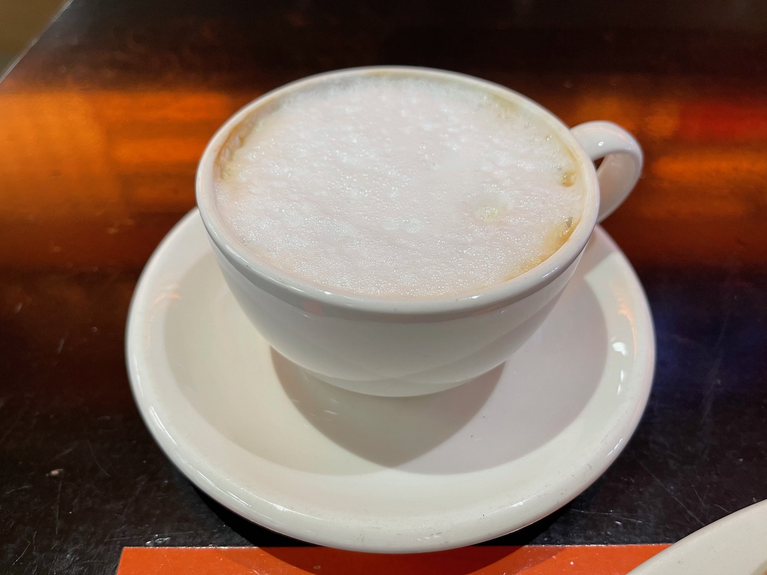 a cup of coffee with foam in it