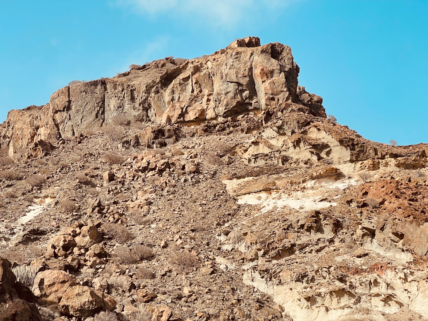 a rocky hill with blue sky