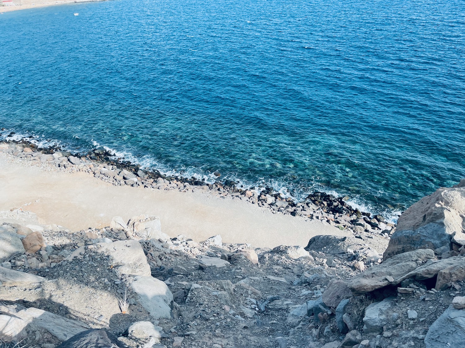 a rocky beach with a body of water