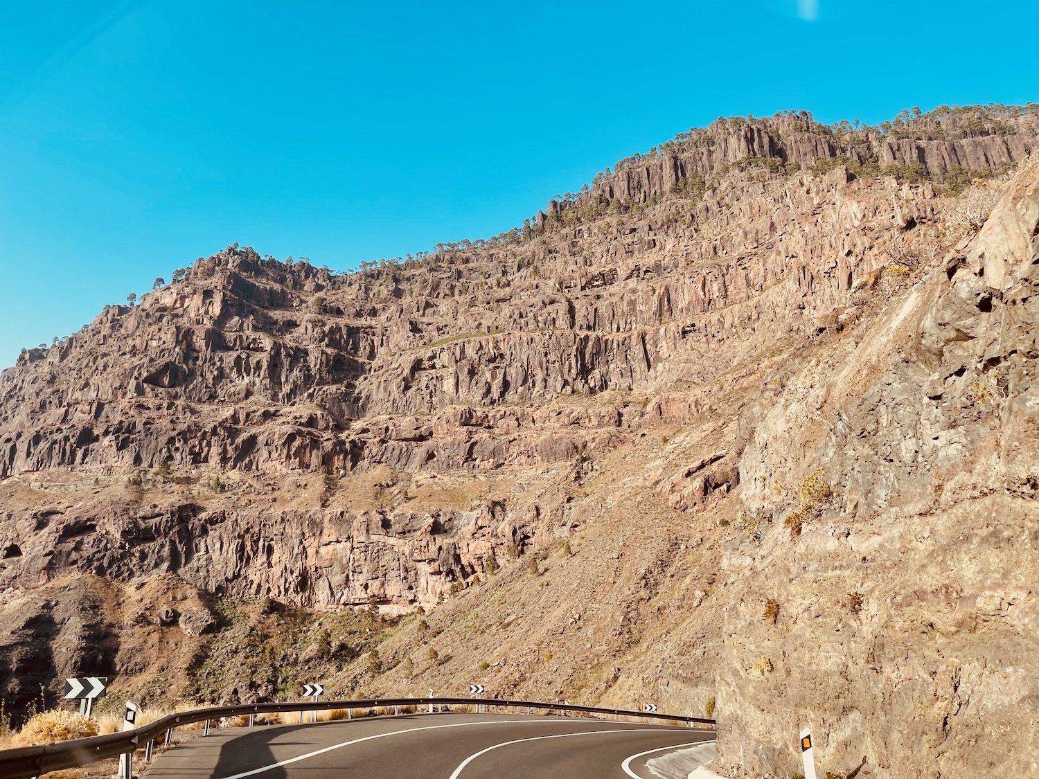 a road with a mountain in the background