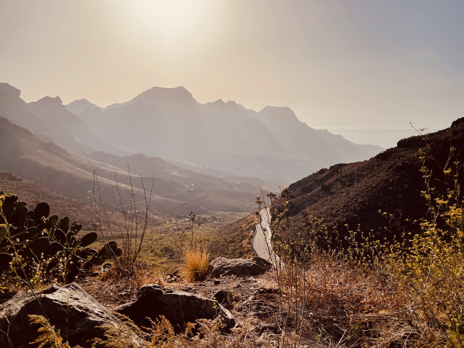 a landscape of mountains and a road