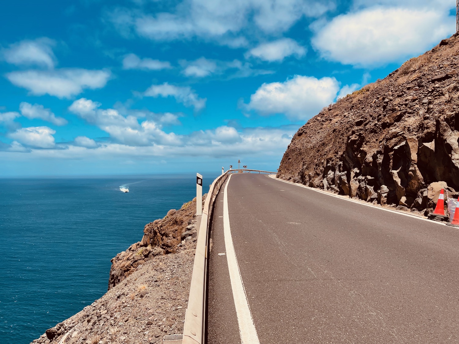 a road with a body of water in the background