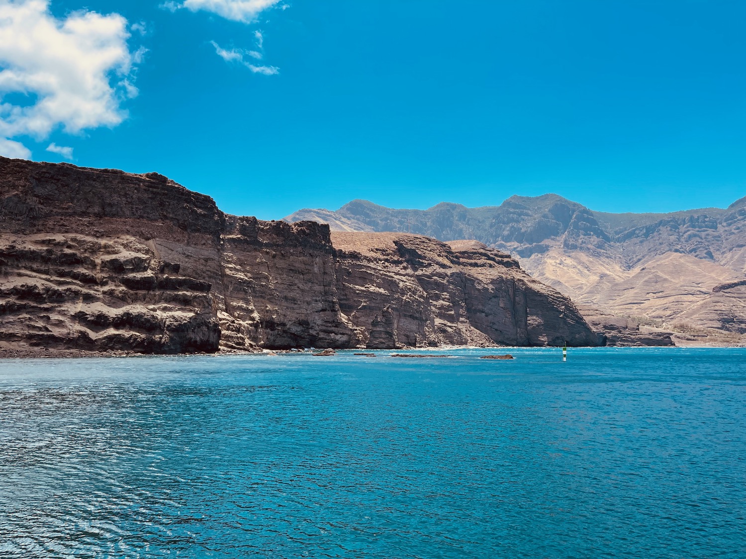 a body of water with mountains in the background