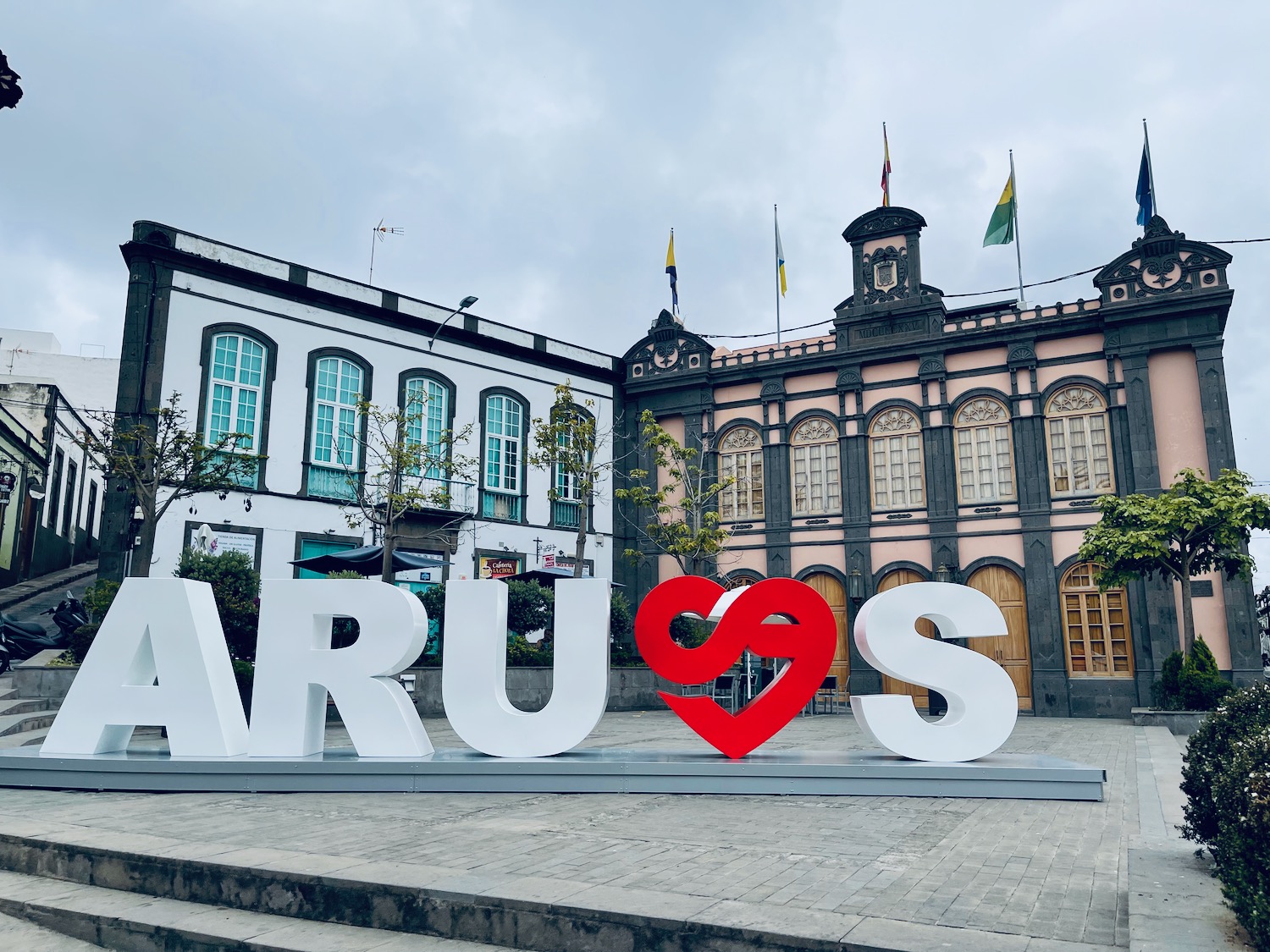 a large white letters in front of a building