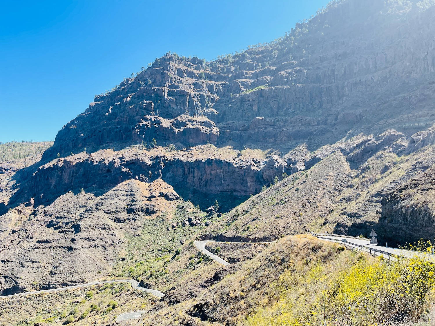 a road going through a rocky mountain