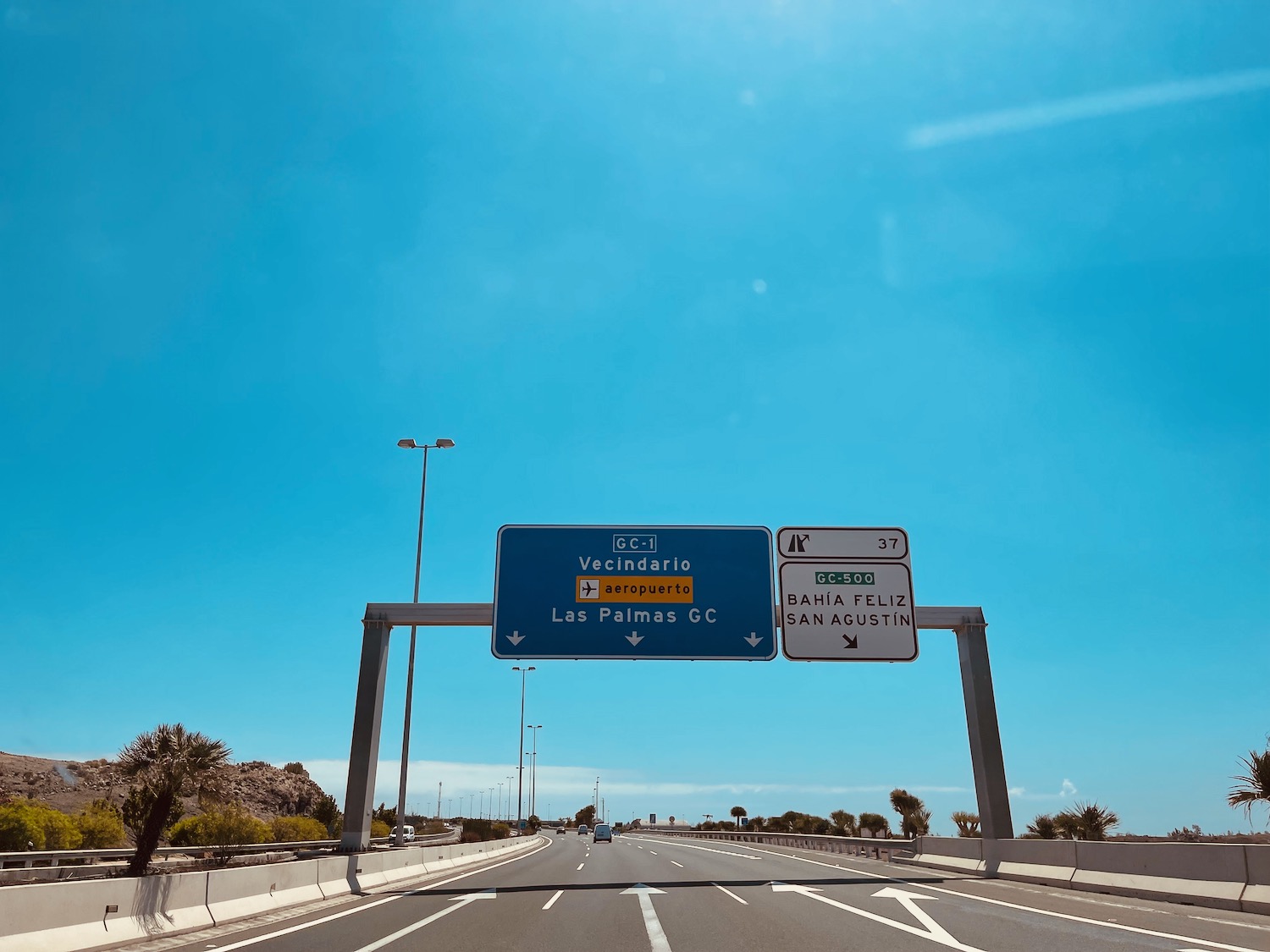 a road with a blue sign