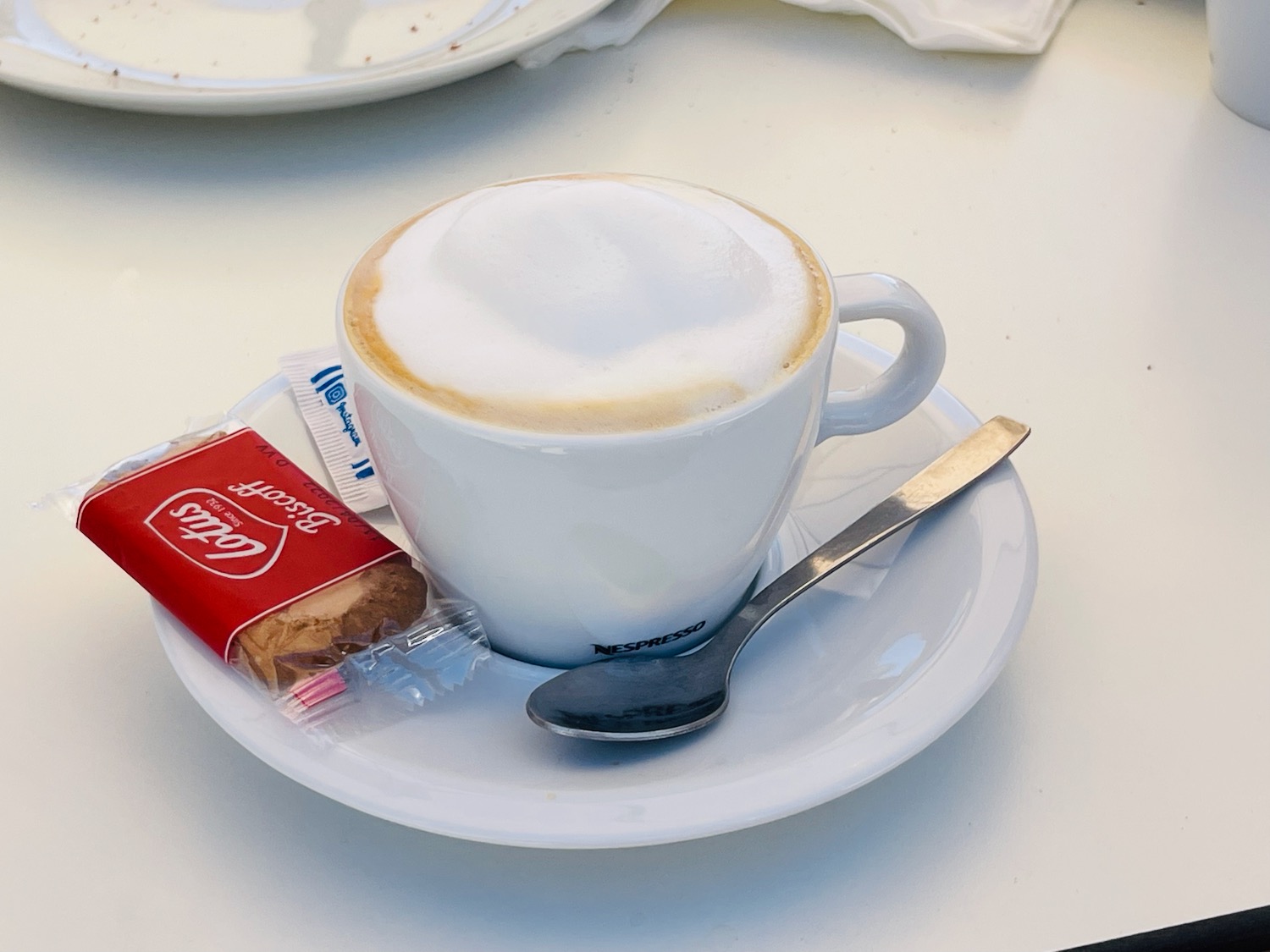 a cup of coffee and a spoon on a plate