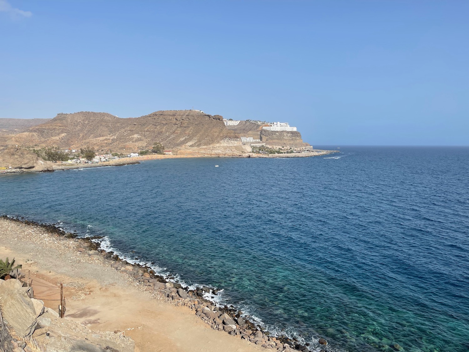 a beach with a rocky shore and a body of water