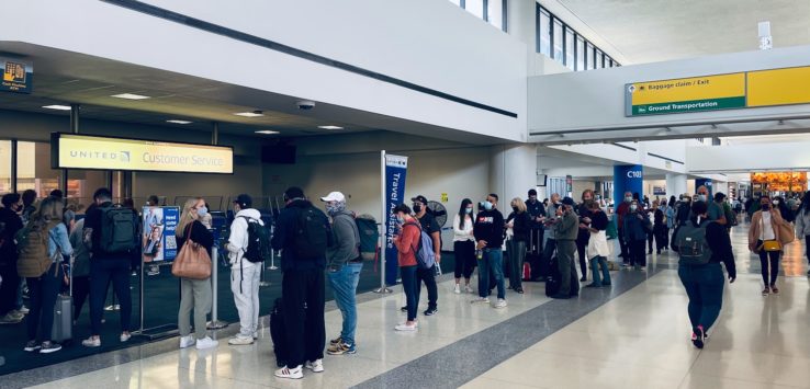 a group of people in a line in an airport