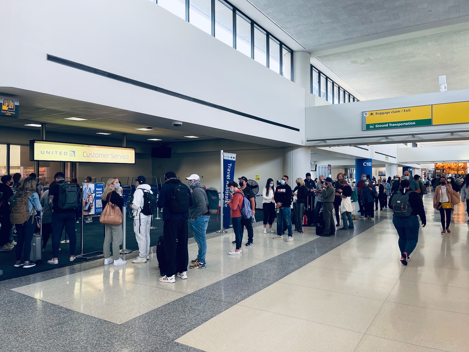 a group of people in a line in an airport