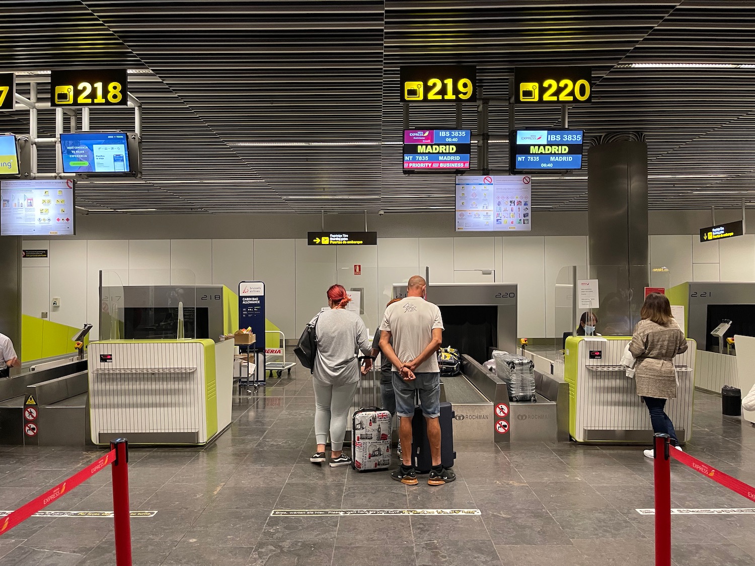 people standing in a room with luggage