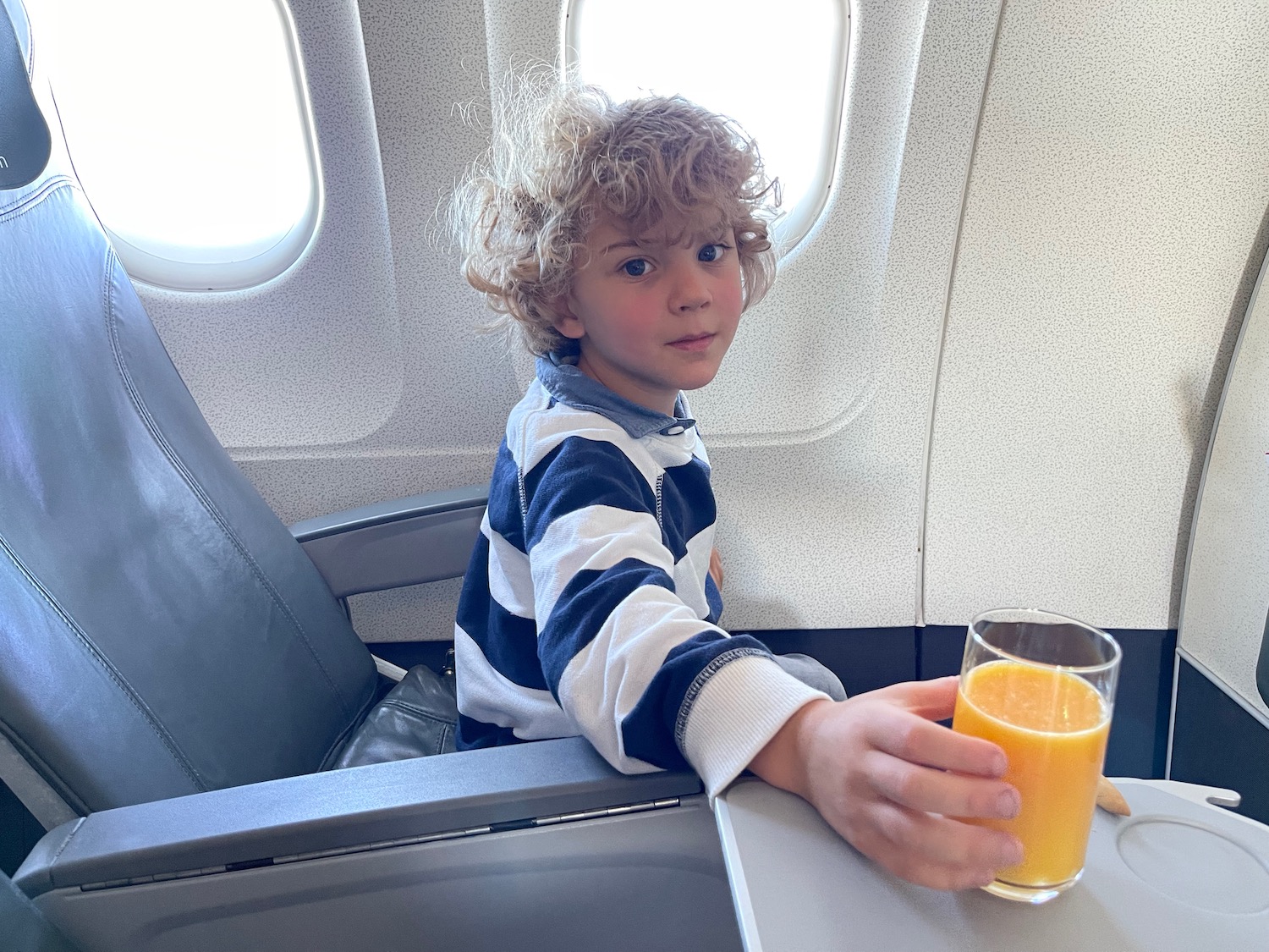 a boy holding a glass of juice
