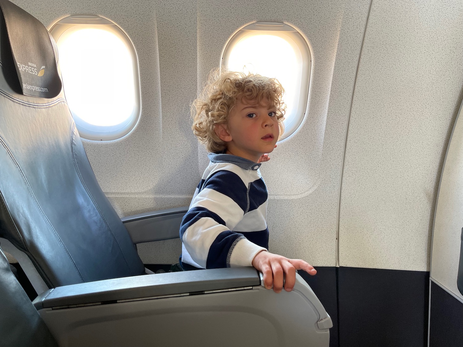 a boy sitting in an airplane