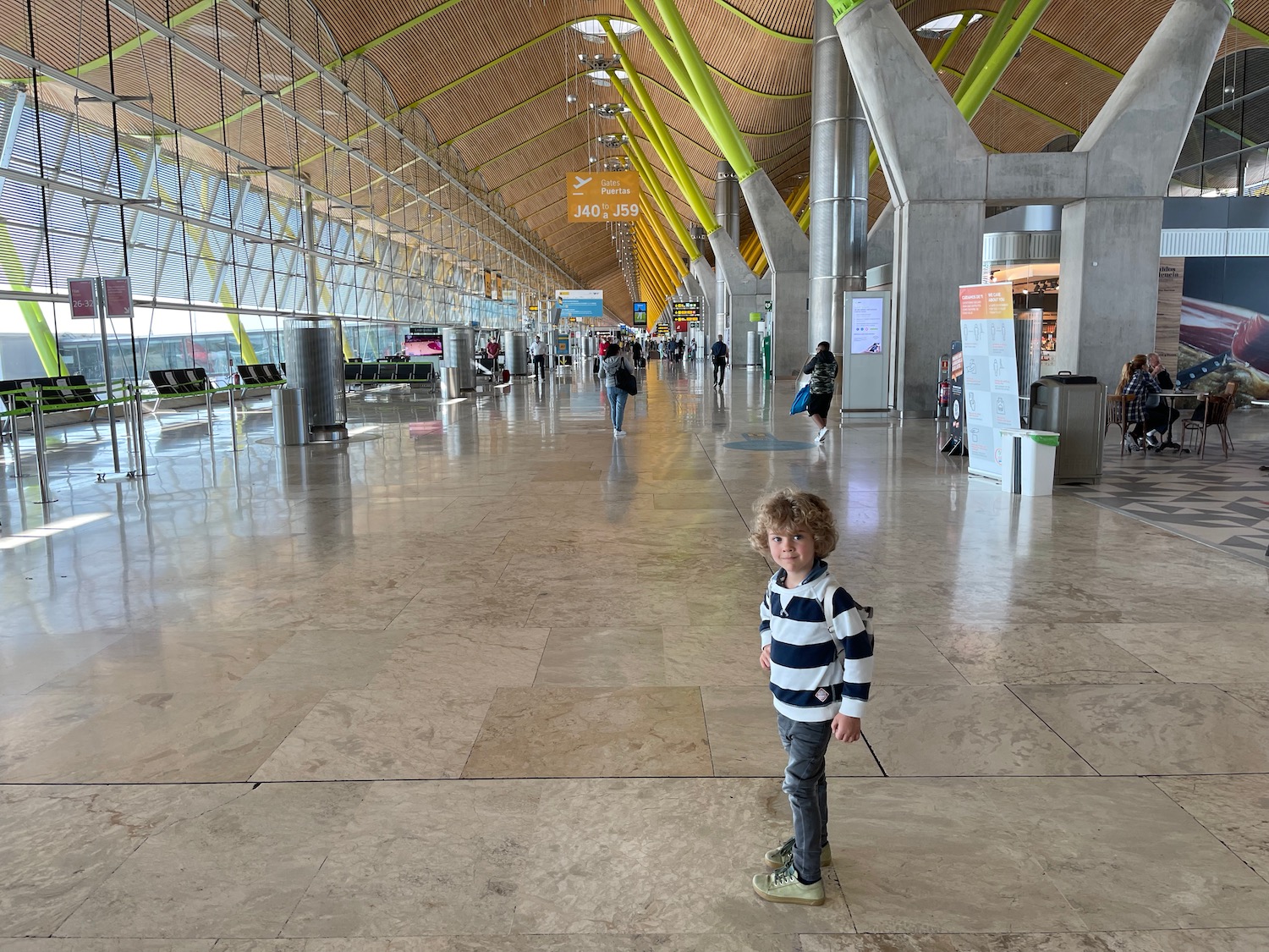 a boy standing in a large airport