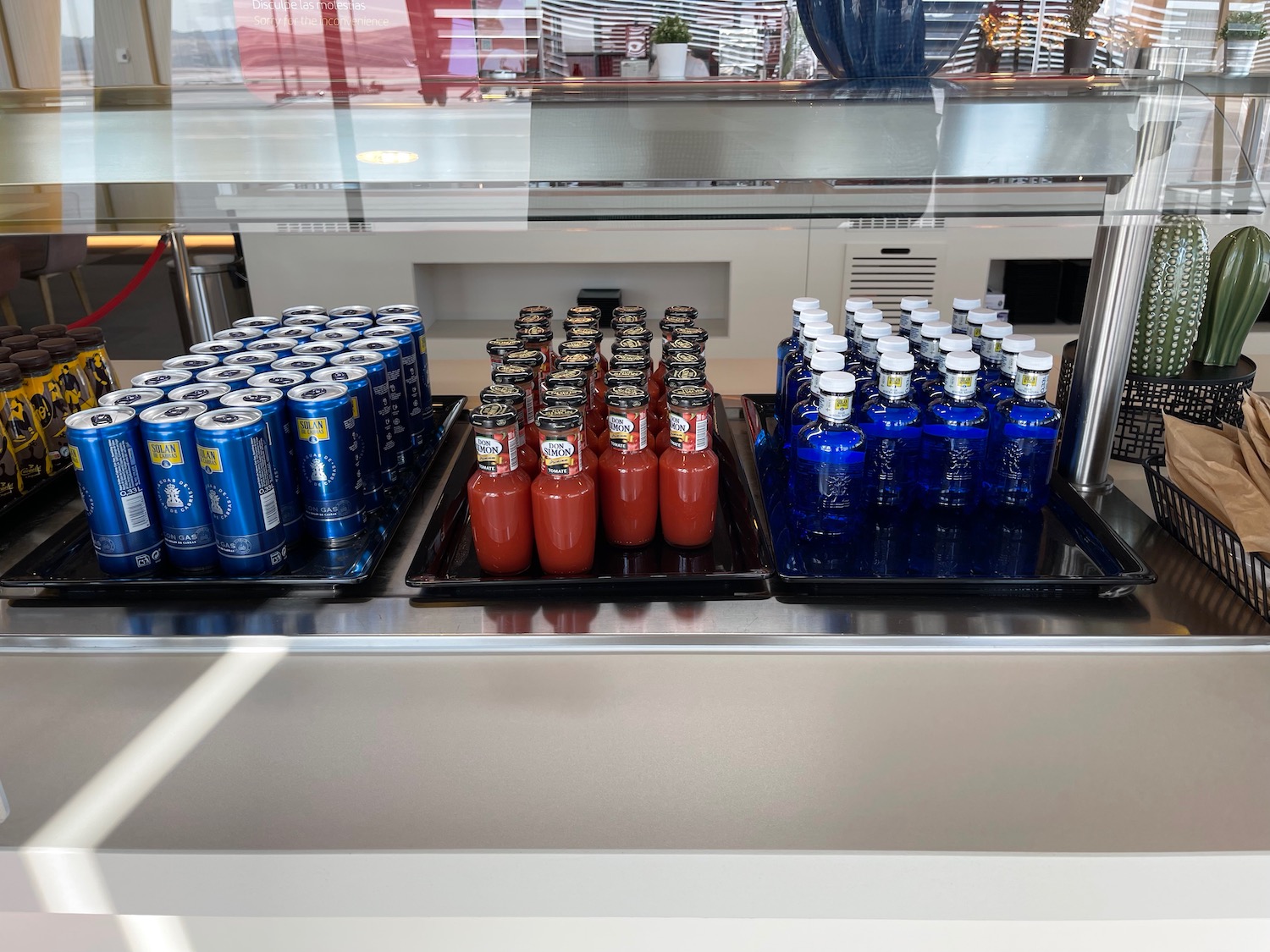 a group of bottles of soda and a drink on a table