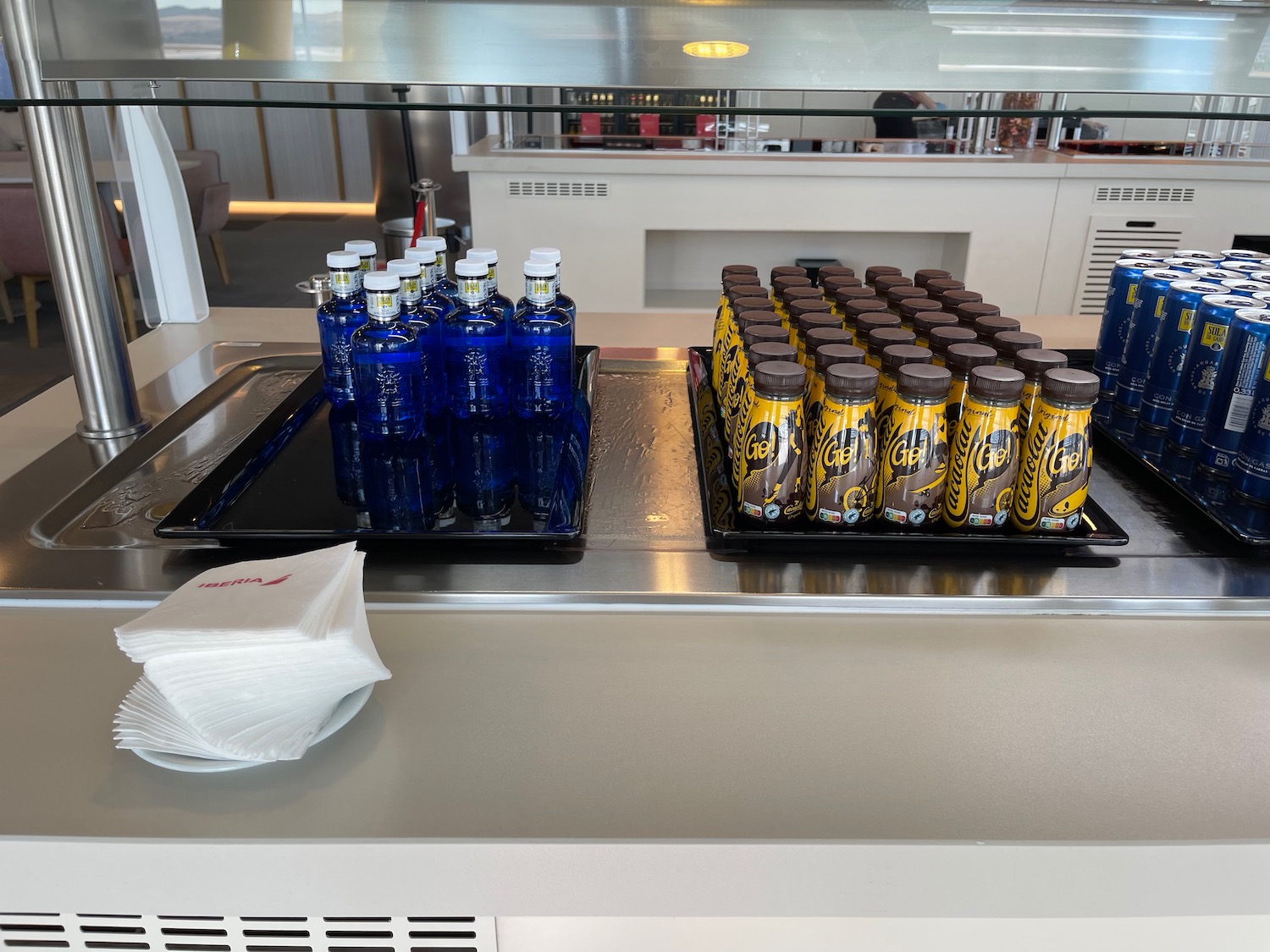 a group of blue bottles and bottles of soda on a table