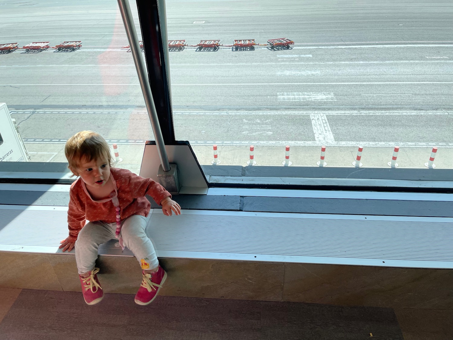 a child sitting on a window sill