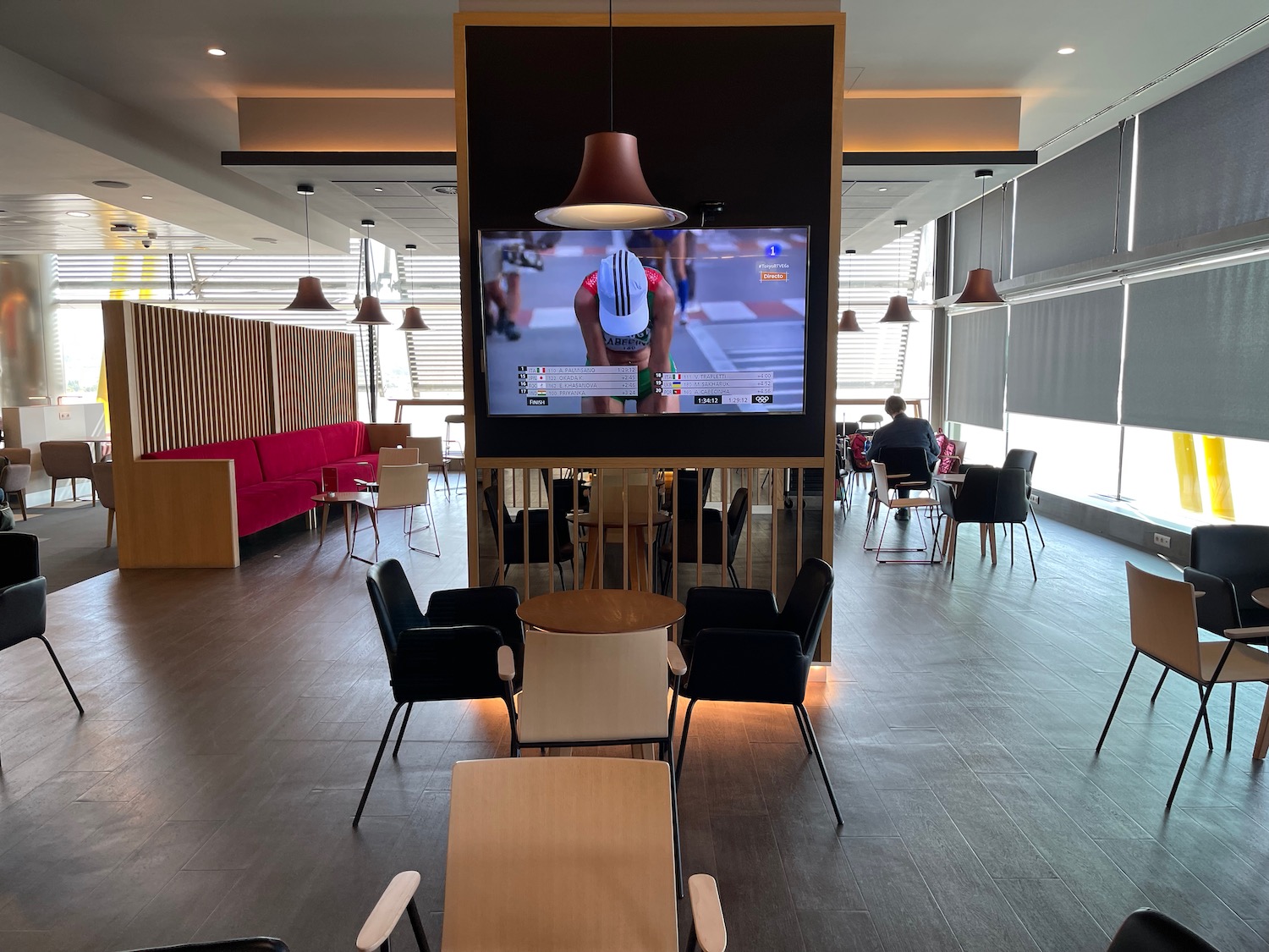 a tv in a room with chairs and tables