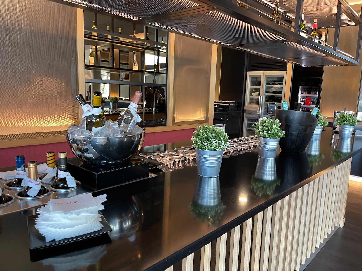 a bar with bottles of wine and plants