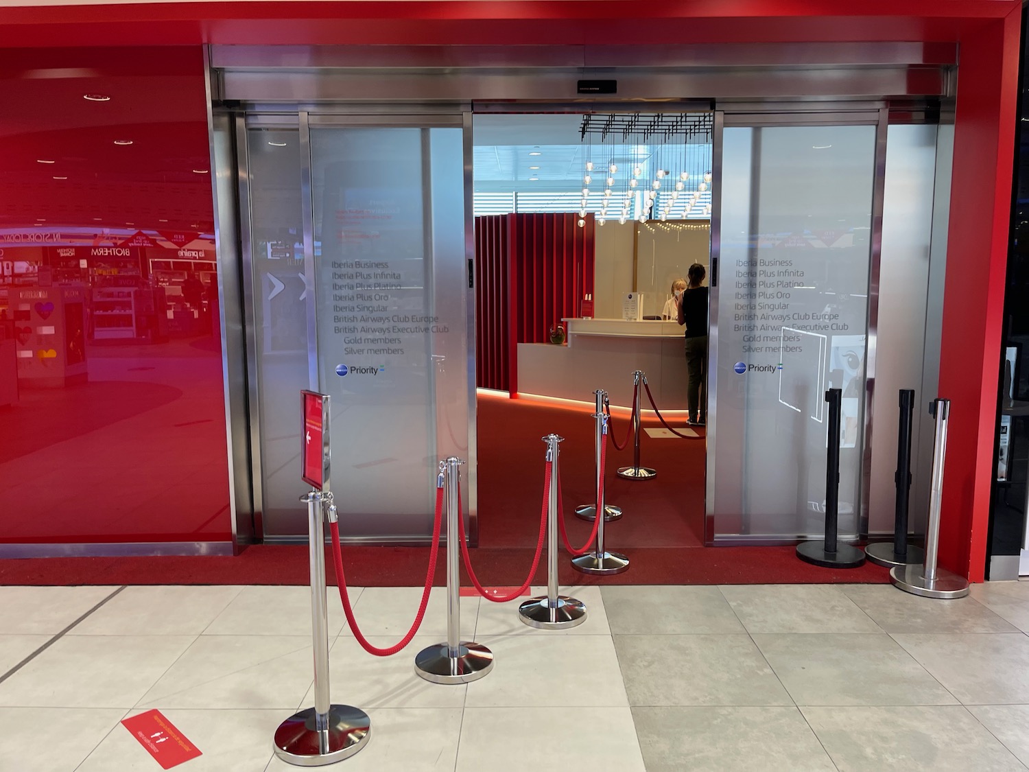 a red carpeted entrance with red rope barriers