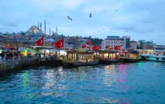 boats on the water with flags